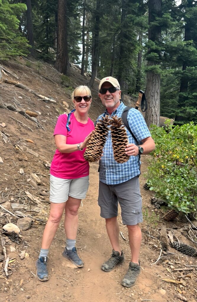 Lisa and Scott holding giant pinecones